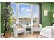 Relaxing sitting area in bedroom with water views and comfy chairs at 120 Brightwater Dr # 2, Clearwater Beach, FL 33767