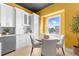 Charming kitchen nook with a round table and chairs, offering a sunny view at 120 Brightwater Dr # 2, Clearwater Beach, FL 33767