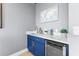 Stylish wet bar with blue cabinetry, quartz countertop, and wine cooler at 120 Brightwater Dr # 2, Clearwater Beach, FL 33767