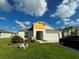 Charming one-story house with a two-car garage and landscaped front yard at 12730 Mangrove Forest Dr, Riverview, FL 33579