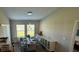 Bright dining room with large windows and wood-look flooring at 12730 Mangrove Forest Dr, Riverview, FL 33579