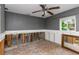 Bedroom features damaged walls, ceiling fan, and a mirror at 1786 Nevada Ne Ave, St Petersburg, FL 33703