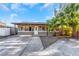Charming home with large driveway and mature landscaping, including palm trees at 1786 Nevada Ne Ave, St Petersburg, FL 33703