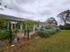 Backyard with patio, flowering bushes, and a fenced area at 232 N Brockfield Dr, Sun City Center, FL 33573