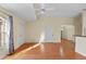 Living room with hardwood floors, ceiling fan, and ample natural light at 38753 Feathering Way, Zephyrhills, FL 33542