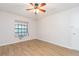 Bright bedroom with wood-look floors, window seat, and ceiling fan at 3925 Shoreside Cir, Tampa, FL 33624