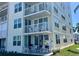 Condo building featuring multiple balconies, patio, and lush landscaping at 6061 Bahia Del Mar Cir # 241, St Petersburg, FL 33715