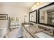 Bathroom features dual sinks with granite countertops and tiled glass shower at 6061 Bahia Del Mar Cir # 241, St Petersburg, FL 33715