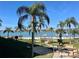 Community offers a sandy beach area near the water, palm trees, landscaping, and water views at 6061 Bahia Del Mar Cir # 241, St Petersburg, FL 33715