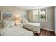Bedroom with two twin beds, natural light and tasteful decor at 6061 Bahia Del Mar Cir # 241, St Petersburg, FL 33715