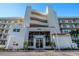 Attractive condo building with white facade, red tiled entrance and well-maintained landscaping at 6061 Bahia Del Mar Cir # 241, St Petersburg, FL 33715
