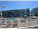 Resort-style community pool area featuring comfortable lounge chairs, tables, and umbrellas for relaxing by the pool at 6061 Bahia Del Mar Cir # 241, St Petersburg, FL 33715