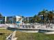 Inviting community pool with lounge chairs and umbrellas, set against a backdrop of well-maintained apartment buildings at 6061 Bahia Del Mar Cir # 241, St Petersburg, FL 33715