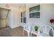 Inviting front porch featuring tile flooring, white chairs, and a view of the building's exterior at 6061 Bahia Del Mar Cir # 241, St Petersburg, FL 33715