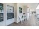 Inviting front porch featuring tile flooring, white chairs, and a view of the building's exterior at 6061 Bahia Del Mar Cir # 241, St Petersburg, FL 33715