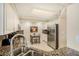 Bright kitchen features stainless steel appliances, granite counters, and a cozy dining area at 6061 Bahia Del Mar Cir # 241, St Petersburg, FL 33715