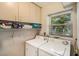 Laundry room with washer, dryer, storage cabinets and window at 6061 Bahia Del Mar Cir # 241, St Petersburg, FL 33715