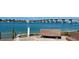 Scenic waterfront view with a park bench, bridge in the distance, and clear blue skies, perfect for relaxation at 6061 Bahia Del Mar Cir # 241, St Petersburg, FL 33715