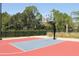 Outdoor basketball court with red and blue surface at 8072 Green Pines Ter, Spring Hill, FL 34606