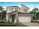 Two-story home with stone accents, two-car garage, and landscaping at 31046 Pendleton Landing Cir, Wesley Chapel, FL 33545