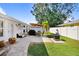 Relaxing patio with seating area, grill, and lush landscaping at 506 Lime Tree Ct, Sun City Center, FL 33573