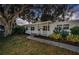 White-painted home with covered porch and landscaping at dusk at 8428 14Th N St, St Petersburg, FL 33702