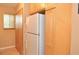 Bright kitchen features stainless steel refrigerator, wood cabinetry, and a nearby closet at 117 114Th N Ave # 117, St Petersburg, FL 33716