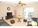 Cozy living room features tile floors, ceiling fan and access to a screened lanai with outdoor seating at 117 114Th N Ave # 117, St Petersburg, FL 33716
