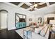 Living room with hardwood floors, coffered ceiling and a large flat-screen TV at 12532 Lillyreed Ct, New Port Richey, FL 34655