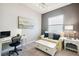 Cozy home office with desk, seating area, and natural light from a window at 12532 Lillyreed Ct, Trinity, FL 34655