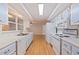 Efficient galley-style kitchen with light-blue cabinets and modern appliances at 989 Virginia St, Dunedin, FL 34698