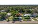 Aerial view of a single-Gathering home with a large backyard and canal at 989 Virginia St, Dunedin, FL 34698