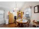 Dining area with wood table and chairs, and storage cabinet at 37827 Mission Hills Ave, Zephyrhills, FL 33541