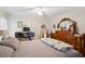 Main bedroom with a wooden bed frame and a ceiling fan at 37827 Mission Hills Ave, Zephyrhills, FL 33541