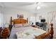 Main bedroom with a wooden bed frame and a ceiling fan at 37827 Mission Hills Ave, Zephyrhills, FL 33541