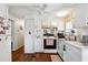 Bright kitchen with white cabinets and wood flooring at 37827 Mission Hills Ave, Zephyrhills, FL 33541