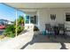 Covered patio with outdoor furniture and grill; a peaceful retreat at 37827 Mission Hills Ave, Zephyrhills, FL 33541
