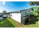 Exterior view of the house, showing the side and yard at 37827 Mission Hills Ave, Zephyrhills, FL 33541