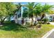 Side view of a manufactured home with lush landscaping at 37827 Mission Hills Ave, Zephyrhills, FL 33541