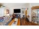 Living room with sofa, TV, fireplace, and display cabinet at 37827 Mission Hills Ave, Zephyrhills, FL 33541