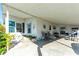 Covered patio with seating area, creating an outdoor living space at 37827 Mission Hills Ave, Zephyrhills, FL 33541