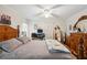 Main bedroom with a wooden bed frame and a ceiling fan at 37827 Mission Hills Ave, Zephyrhills, FL 33541