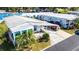 Aerial view of a manufactured home with a carport and landscaping at 37827 Mission Hills Ave, Zephyrhills, FL 33541