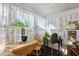 Bright sunroom with wood table and chairs, offering ample natural light at 37827 Mission Hills Ave, Zephyrhills, FL 33541