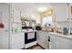 White kitchen with appliances and double sink at 37827 Mission Hills Ave, Zephyrhills, FL 33541