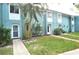 Light blue townhome exterior with grassy yard at 117 114Th N Ave # 117, St Petersburg, FL 33716
