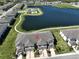 Aerial view showing a townhome with a community pool and lake at 928 Royal Empress Dr, Ruskin, FL 33570