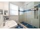 Bathroom with a walk-in shower and blue tile accents at 316 Jasmine Way, Clearwater, FL 33756