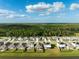 Aerial view of a community with solar panels and lush green surroundings at 15502 Black Pepper Ln, Odessa, FL 33556