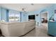 Relaxing living room, featuring a large sectional sofa and a view of the water at 15502 Black Pepper Ln, Odessa, FL 33556